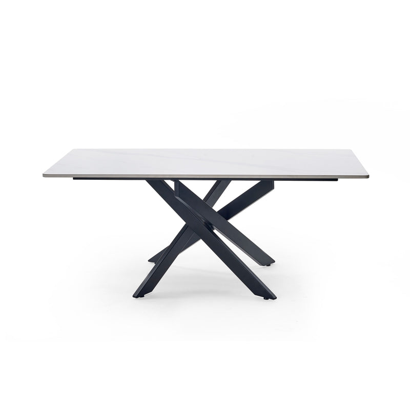 Modern dining table with white marble top and black metal legs on a white background