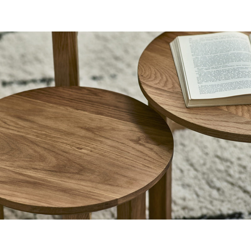 Wooden side table with a book on a textured surface