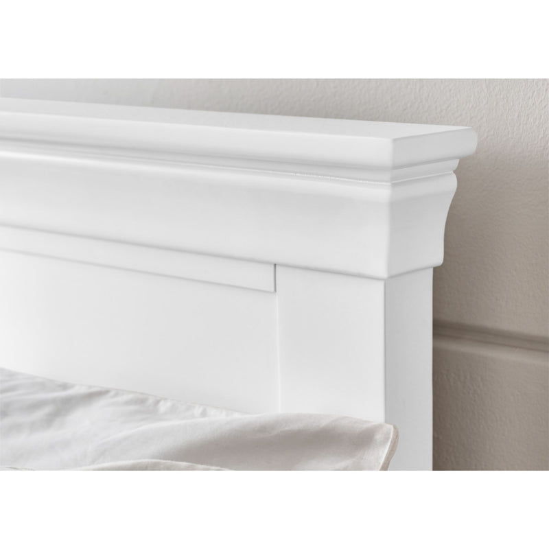 White fireplace mantel against a neutral wall