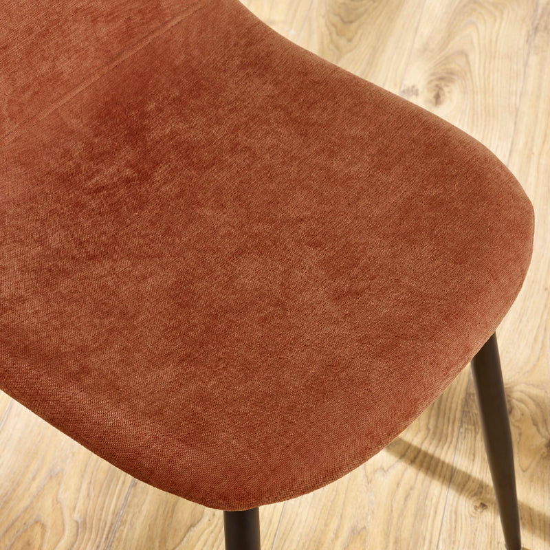 Brown upholstered chair seat on a wooden floor