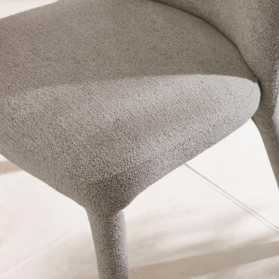 Close-up of a textured gray chair on a light background