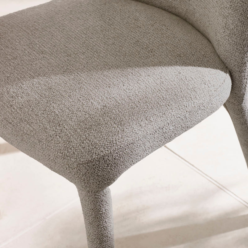 Close-up of a textured gray chair on a light background
