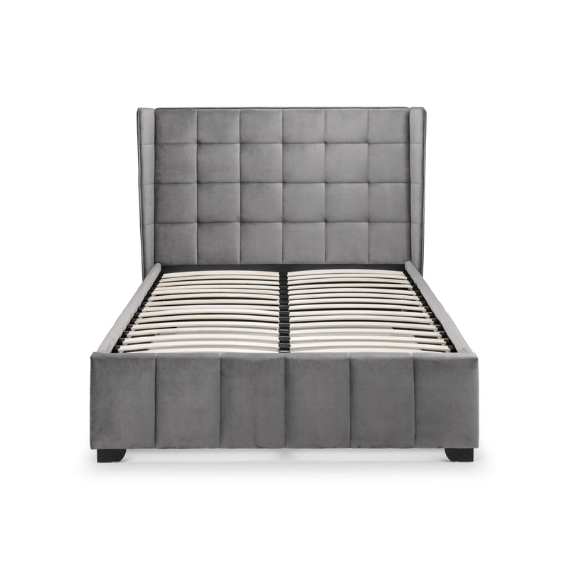 Gray upholstered bed with tufted headboard on a white background