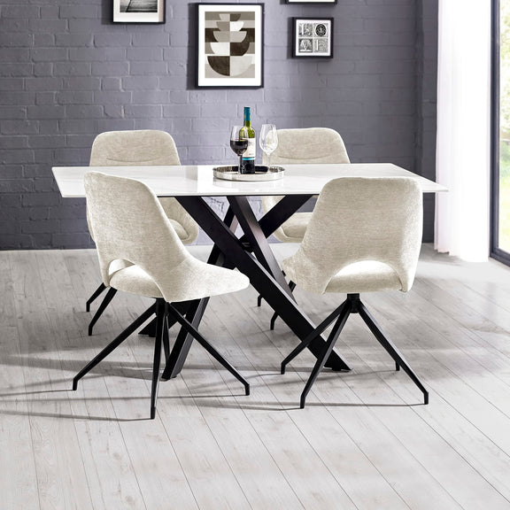 Dining table with four chairs in a modern room with gray walls and a window.