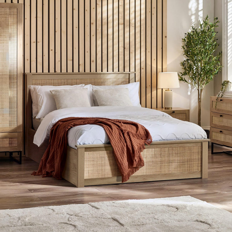 Wooden bed with white bedding and a red blanket in a bedroom setting.