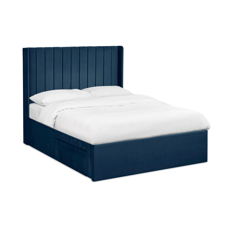 Navy bed frame with white bedding on a white background