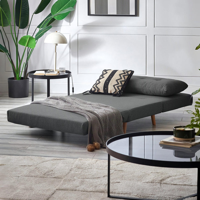 Gray sofa bed in a modern living room with decor elements.