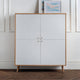 White cabinet with wooden frame and legs against a white wall