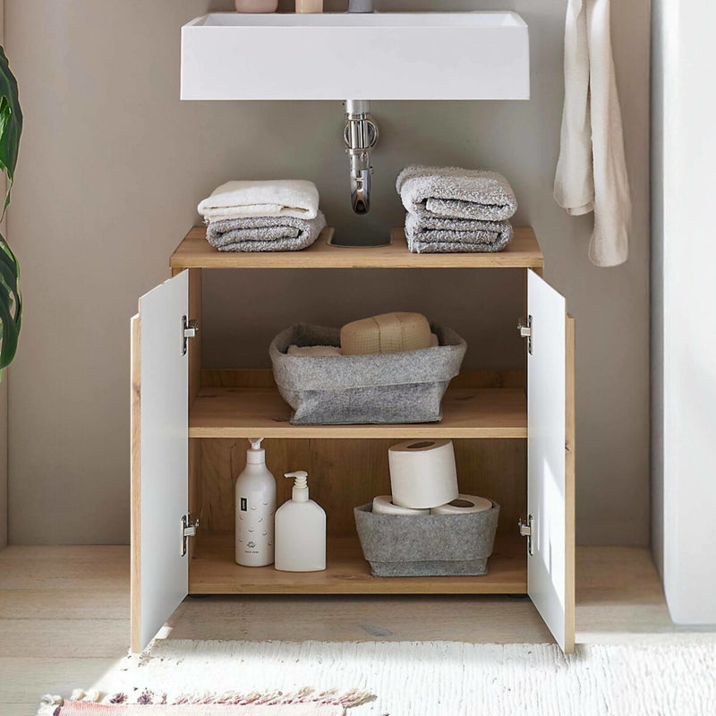 Bathroom cabinet with towels and toiletries on a neutral background