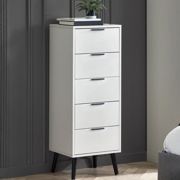 White five-drawer dresser against a gray wall with a plant on top