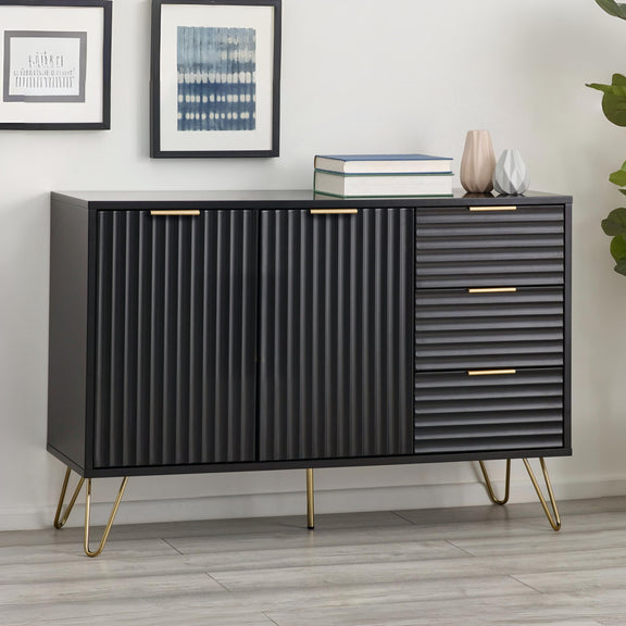Black ribbed sideboard with gold legs in a room setting