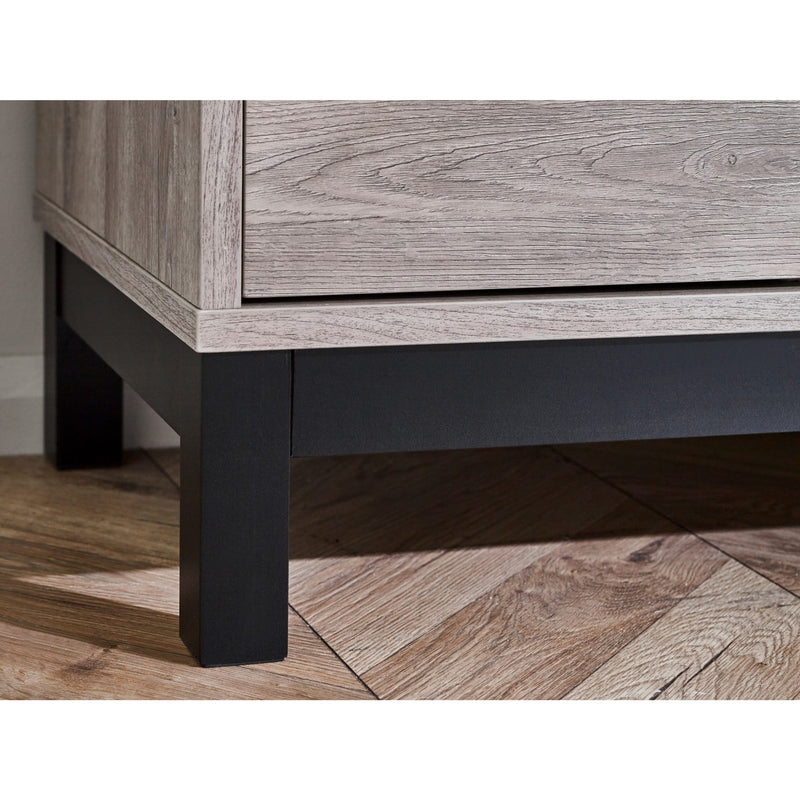 Wooden furniture with a dark leg on a wooden floor