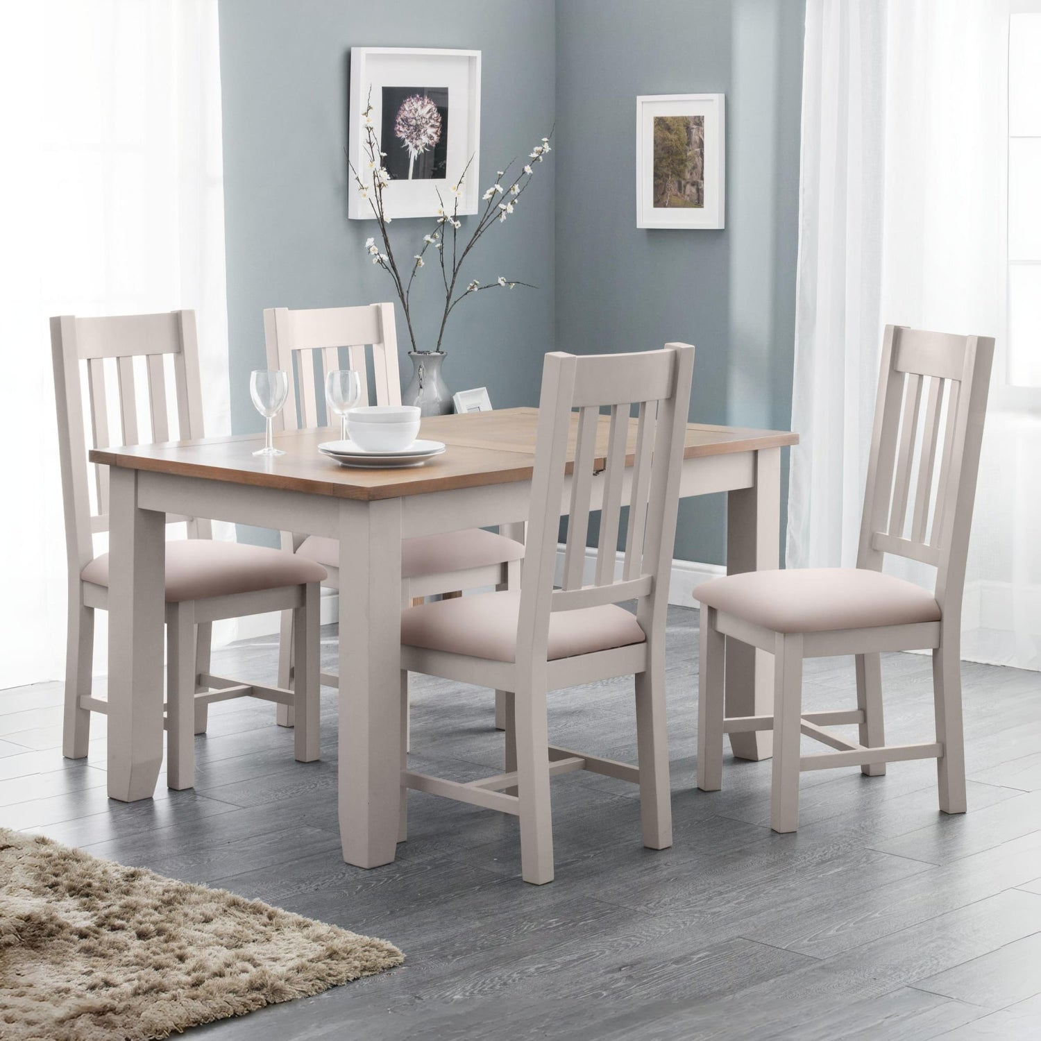 Dining room with a wooden table and four matching chairs in a well-lit room.