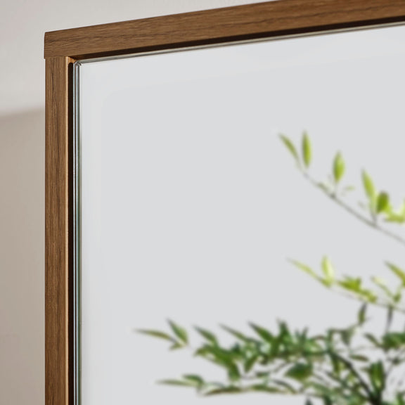 Framed artwork with a plant in the foreground