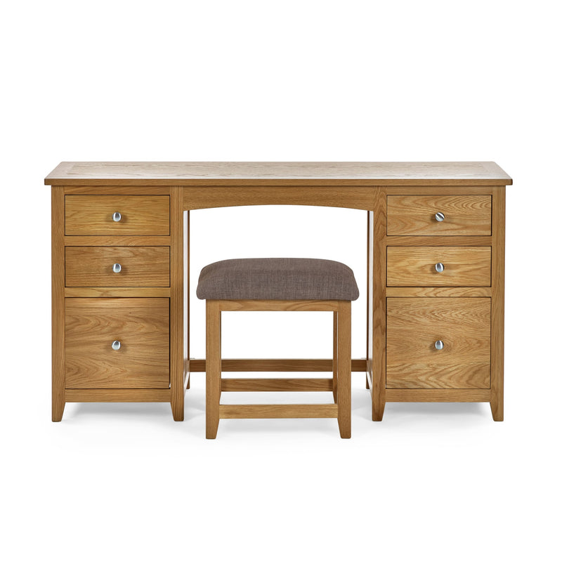 Wooden desk with multiple drawers and a matching stool on a white background