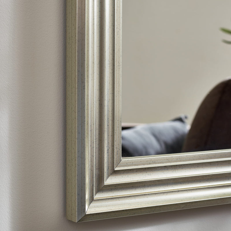 Silver-framed mirror on a neutral wall