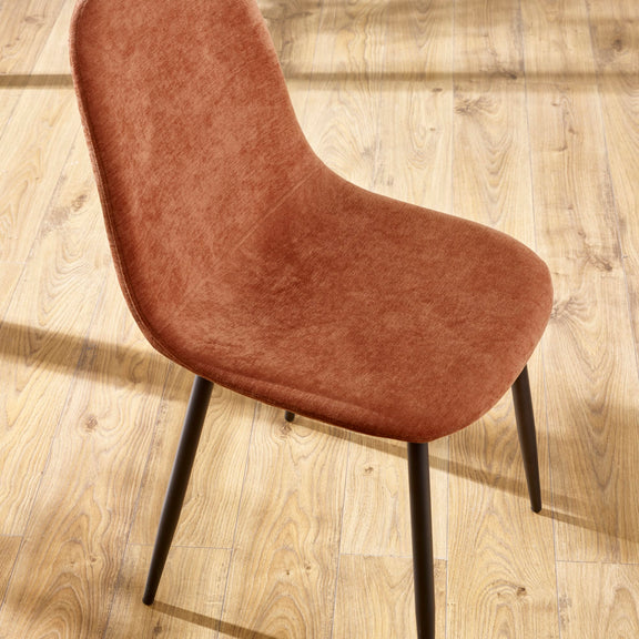 Brown upholstered chair on a wooden floor