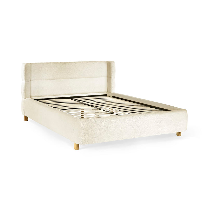 Beige upholstered bed frame on a white background