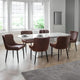 Dining room with a round glass table and six brown chairs.