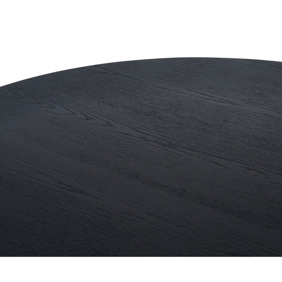 Round black table top with a textured surface on a white background