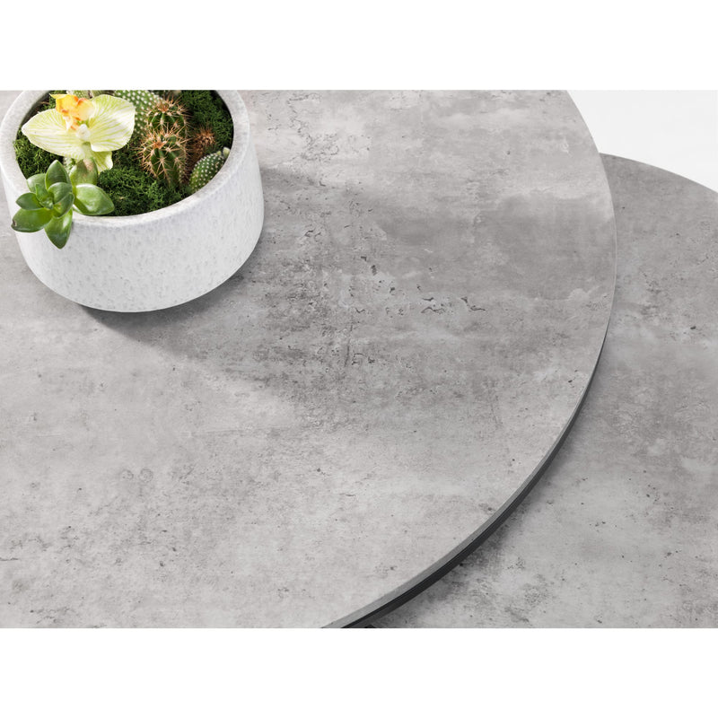 Round concrete table with a small potted plant on a white background