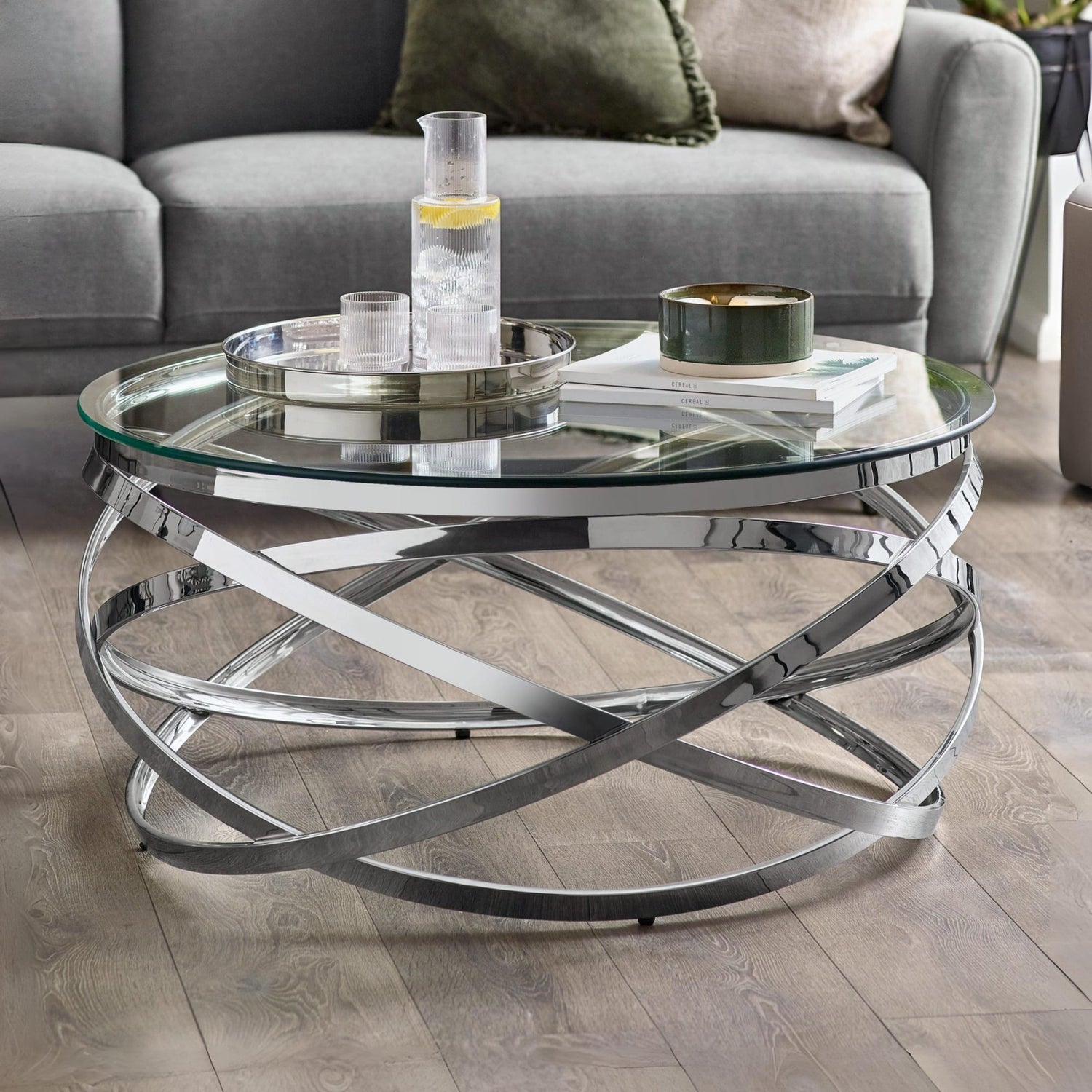 Glass coffee table with metal base in a living room setting