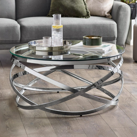 Glass coffee table with metal base in a living room setting