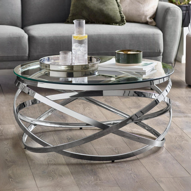 Glass coffee table with metal base in a living room setting