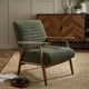 Green armchair in a room with wooden furniture and decor