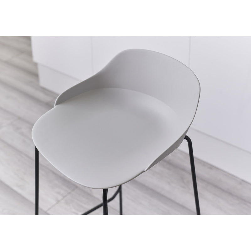 Modern white chair with black legs on a light wooden floor.