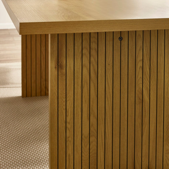 Close-up of a wooden deck with horizontal slats and a textured floor.
