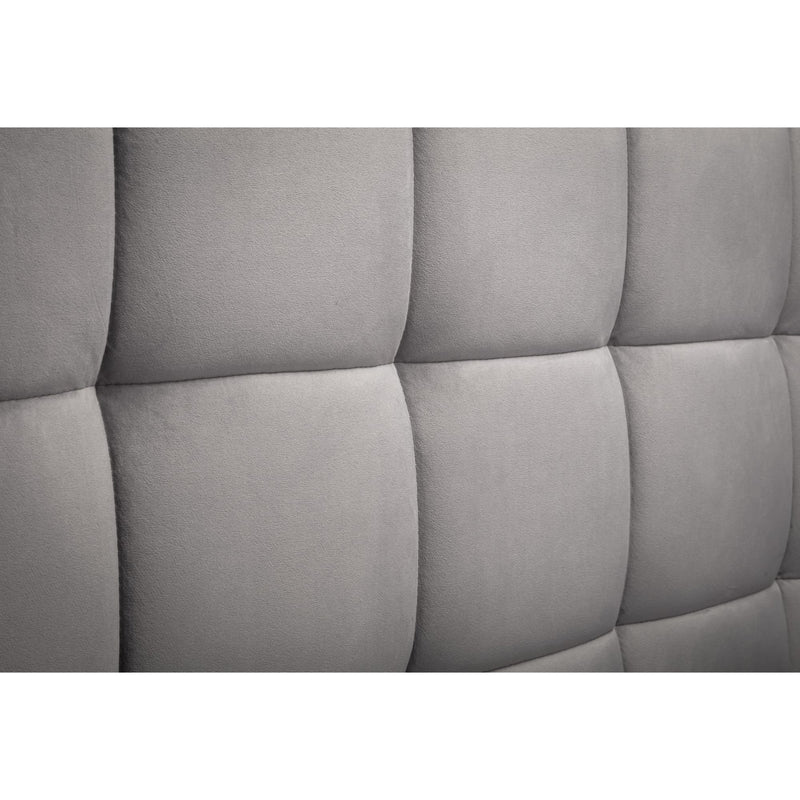 Gray tufted headboard with a quilted pattern on a white background