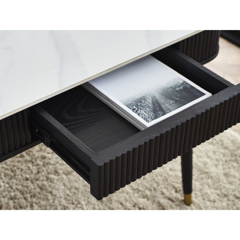 Coffee table with an open drawer revealing a book on a carpeted floor.