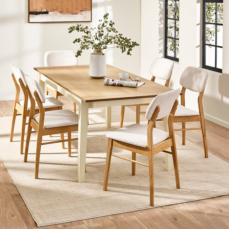 Dining room with wooden table and chairs on a light wood floor.