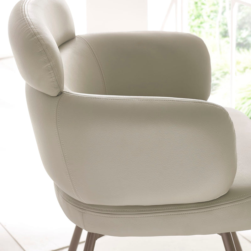 Beige armchair in a bright room with natural light