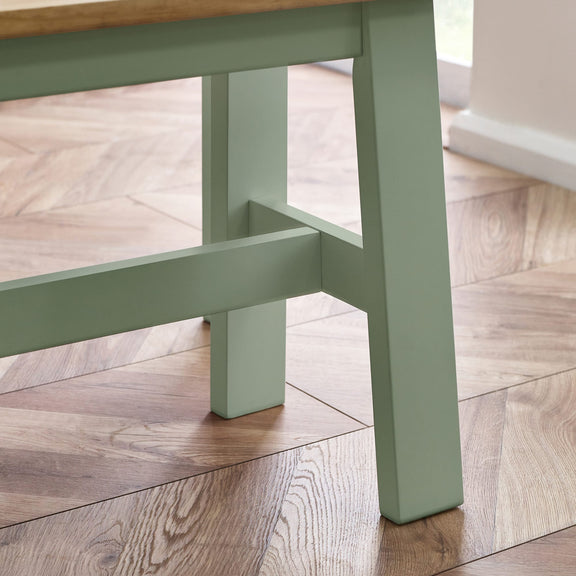 Green wooden stool on a wooden floor