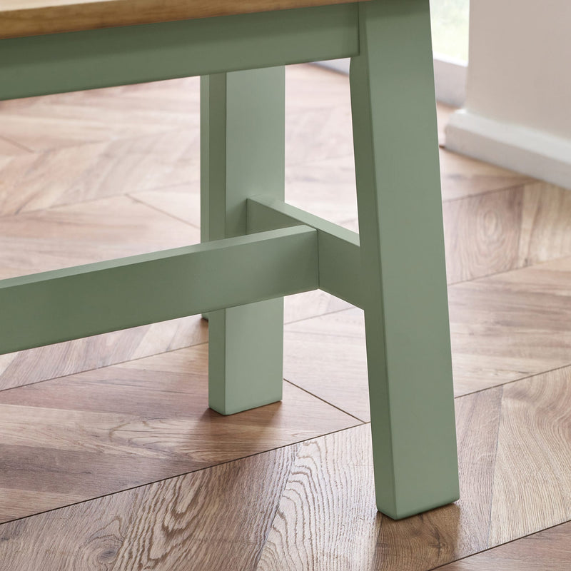 Green wooden stool on a wooden floor