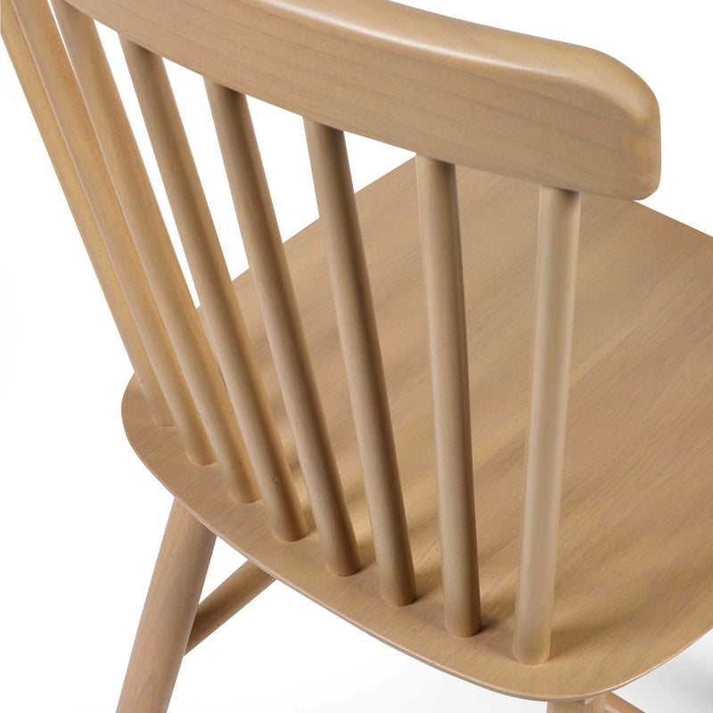 Close-up of a wooden chair with slatted backrest on a white background