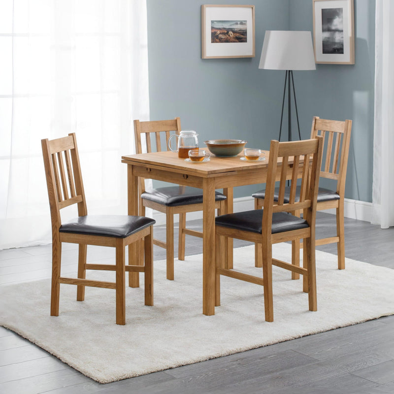 Dining set with wooden table and chairs in a room with light blue walls and a lamp.
