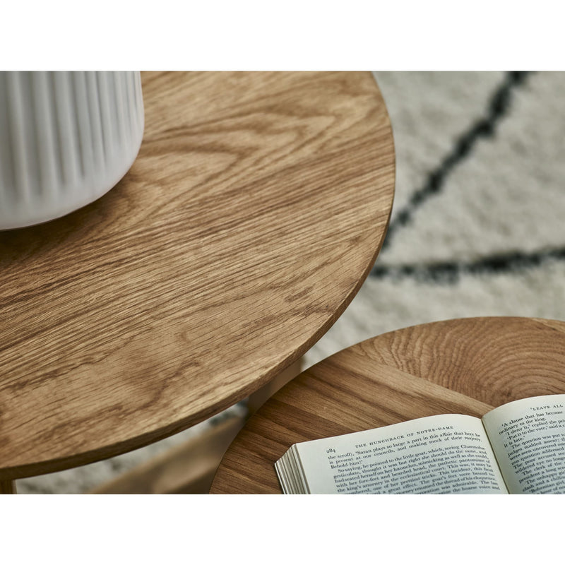 Wooden side table with a white ceramic cup and an open book on a textured surface.