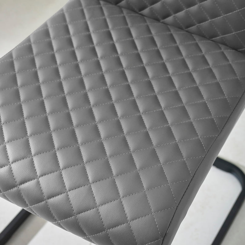 Gray quilted chair cushion on a chair with a white background