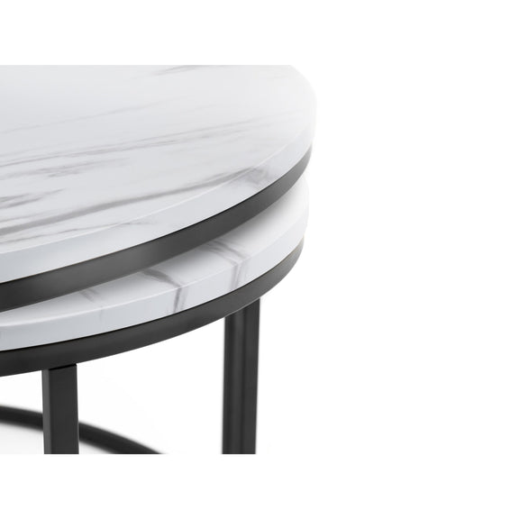 Round table with marble-like top and black metal frame on a white background