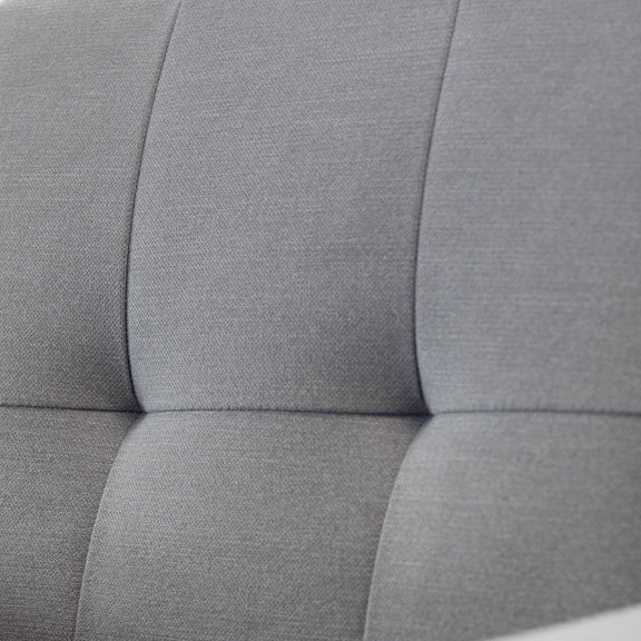 Close-up of a gray upholstered headboard