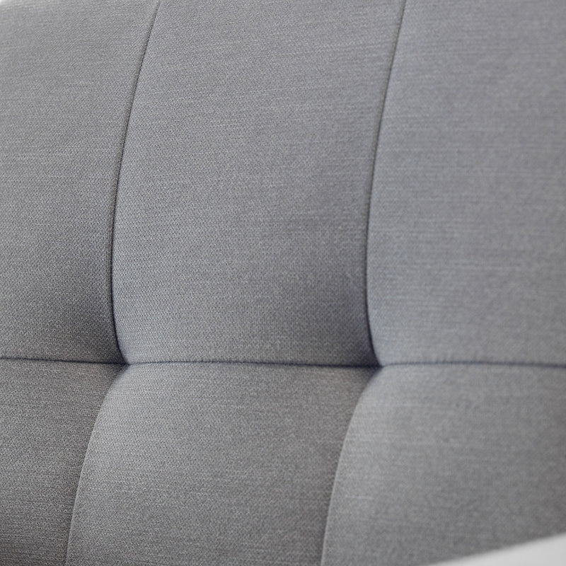 Close-up of a gray upholstered headboard