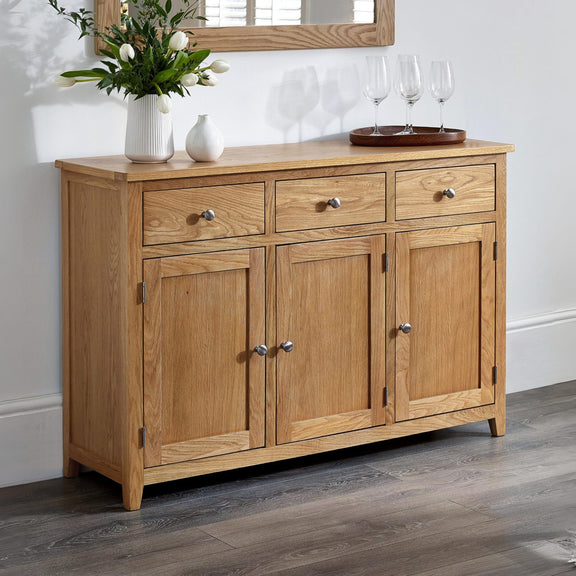 Wooden sideboard with decorative items in a room setting