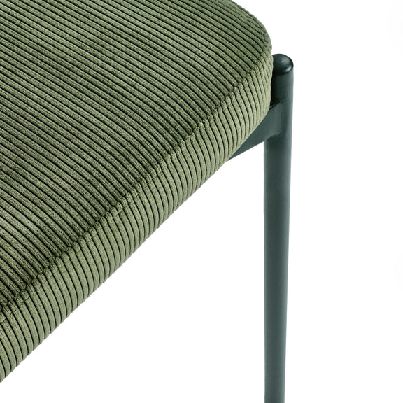 Close-up of a green corduroy chair with a black metal frame on a white background