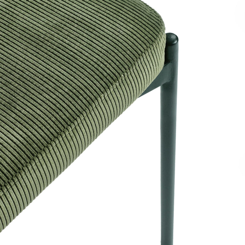 Close-up of a green corduroy chair with a black metal frame on a white background